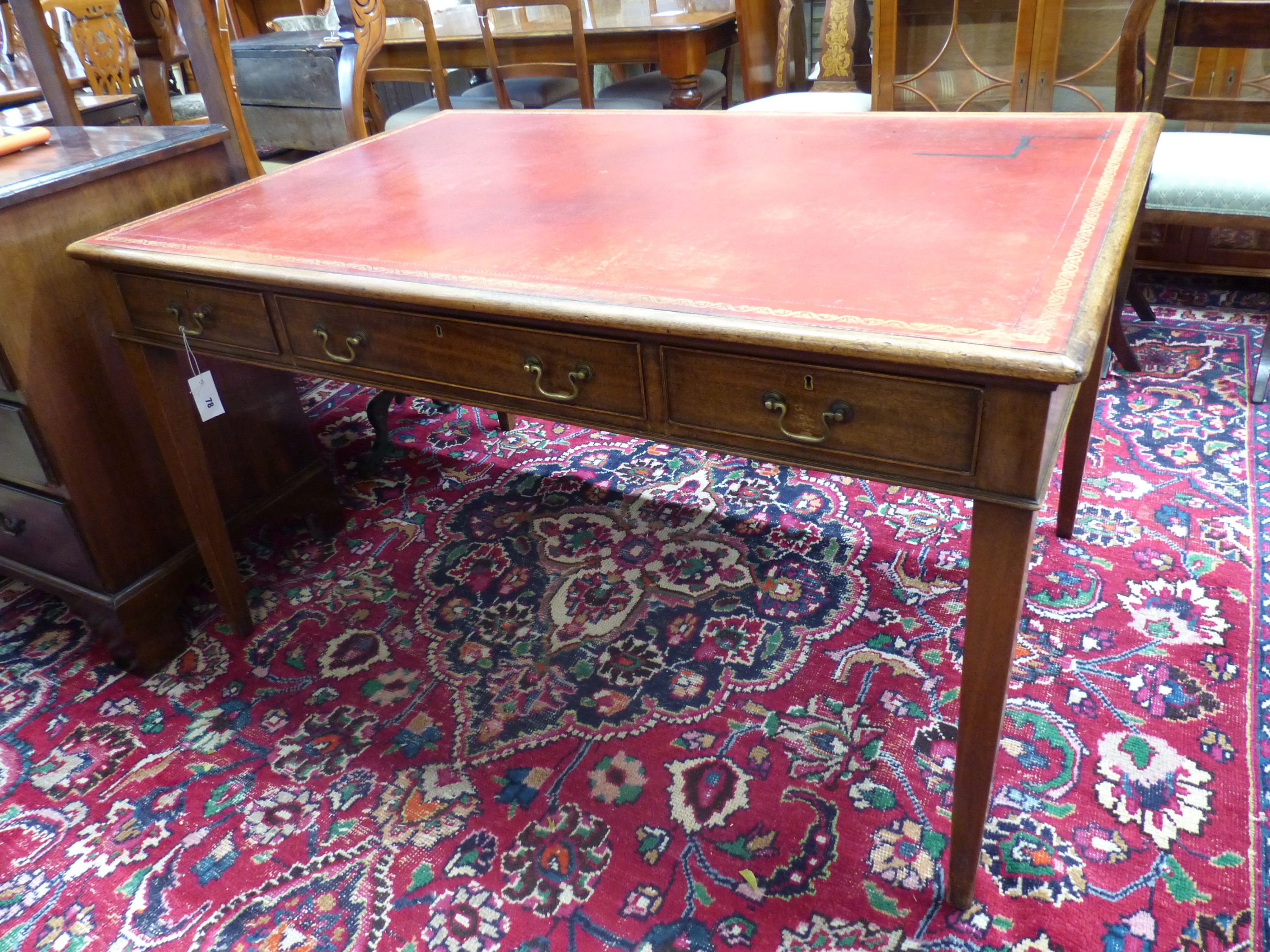 A George III style rectangular mahogany writing table, width 136cm, depth 91cm, height 75cm